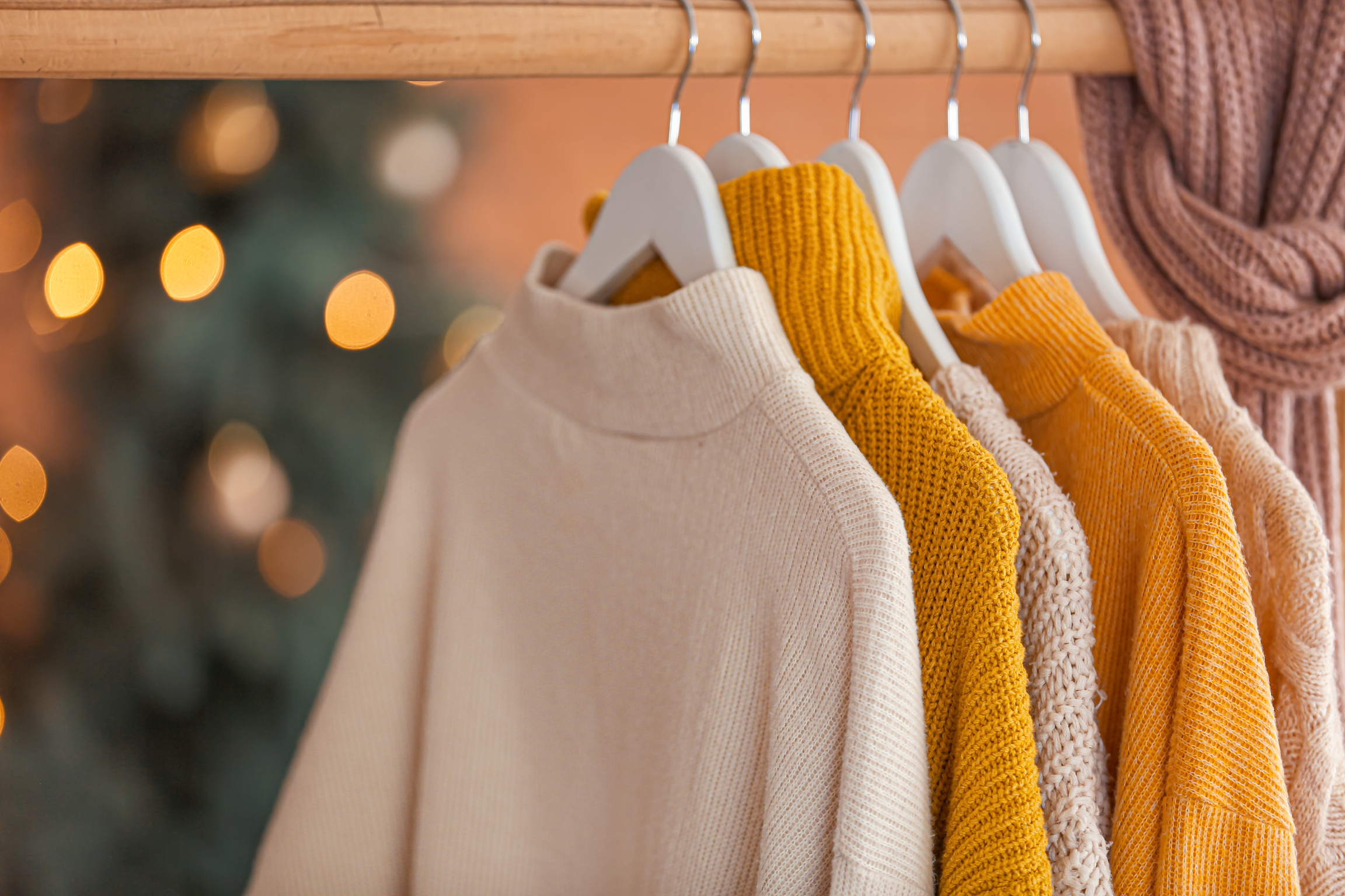 Rack with Winter Clothes at Home on Christmas Eve